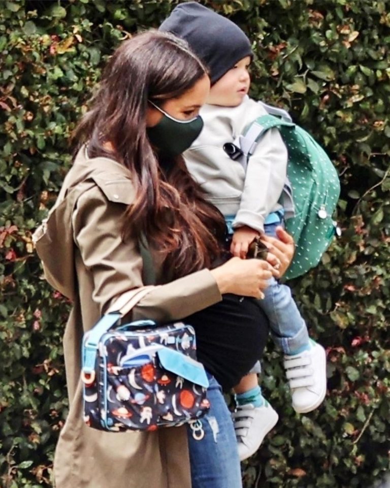 Son Archie was dressed for warmth and carried his school bag on his back.